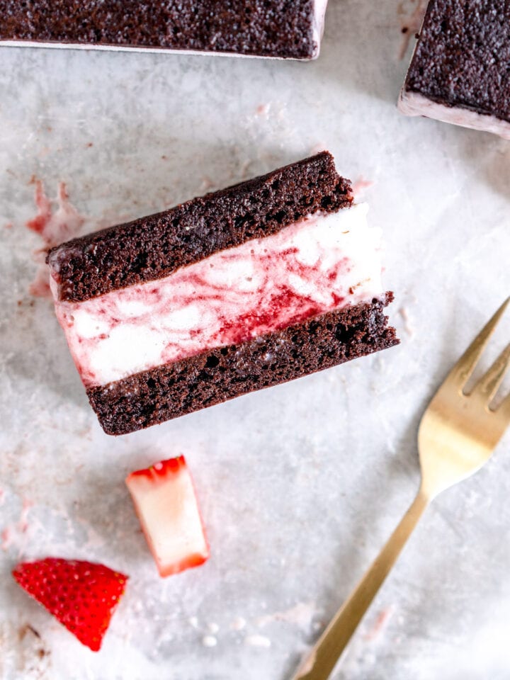 brownie ice cream sandwich with strawberry sauce