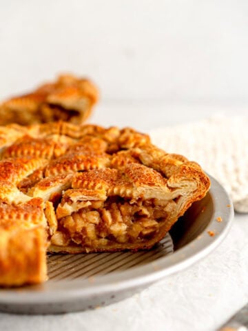 side on shot of apple pie in pan