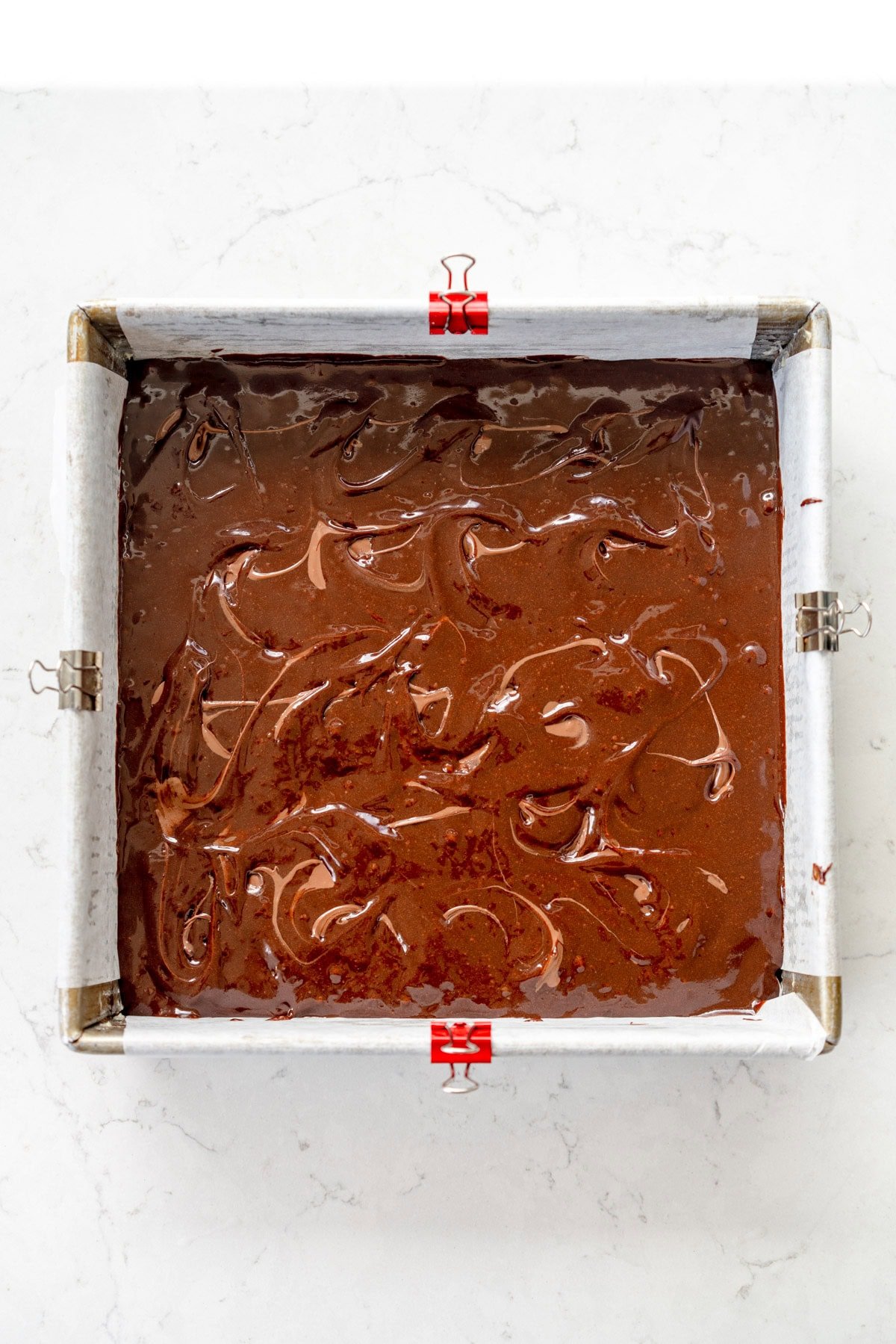 blobs of Nutella added to brownie