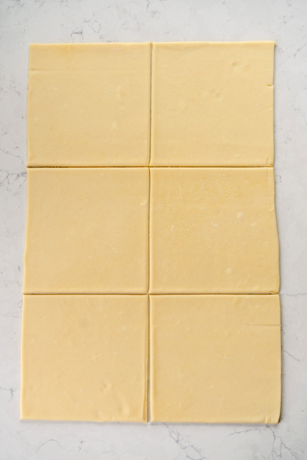 rolled out squares of puff pastry