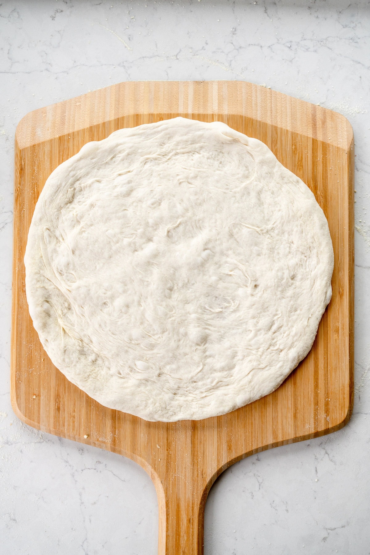 stretched out pizza dough