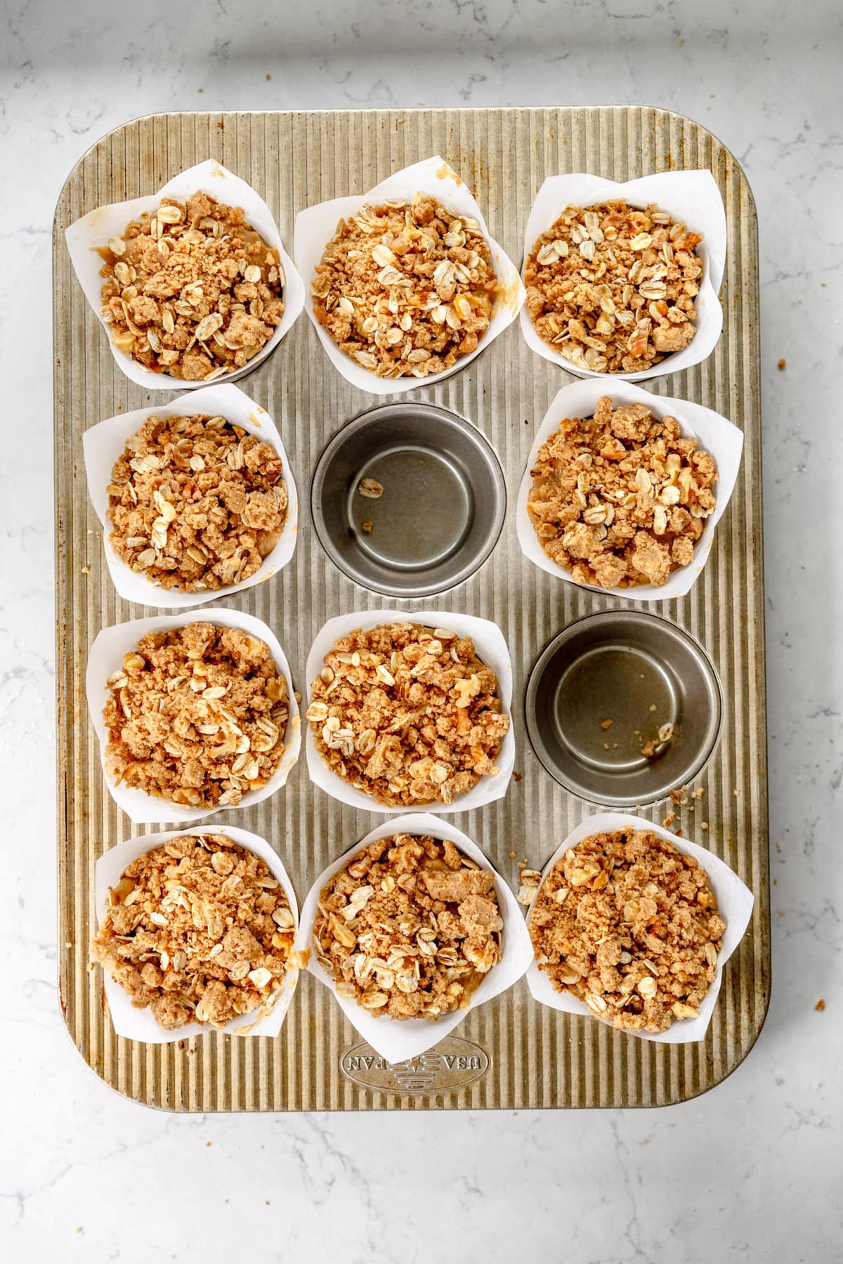filled muffin pans with streusel topping