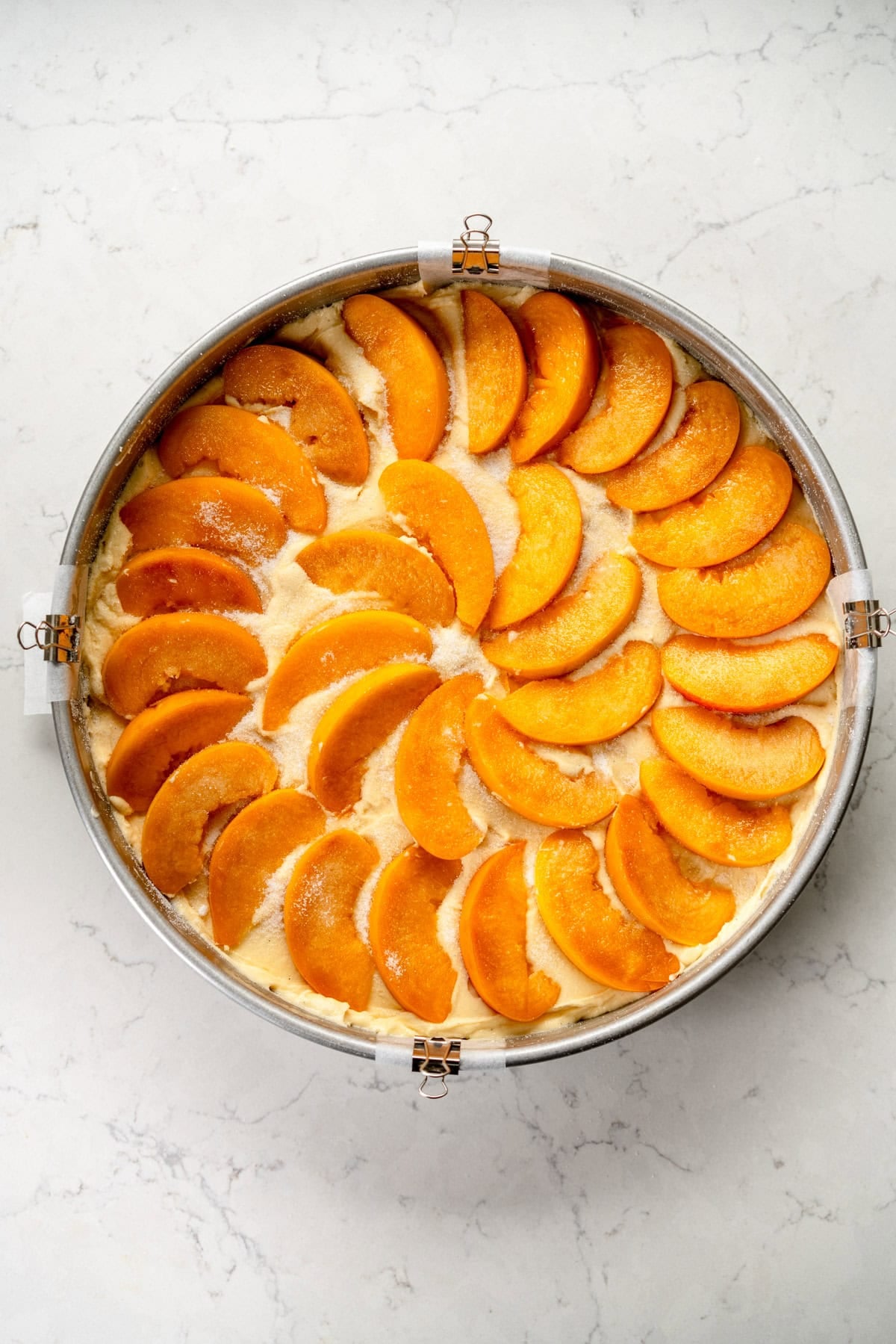 peach slices arranged on cake
