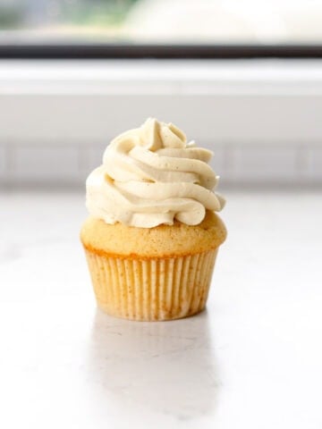 vanilla frosting piped on a cupcake